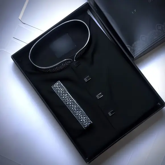 Black men's panjabi with white and black geometric embroidered collar and cuffs, silver rectangular buttons, displayed in a black gift box