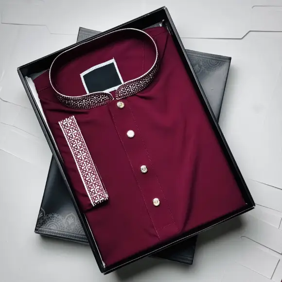 Maroon men's panjabi with white and maroon geometric embroidered collar and cuffs, golden round buttons, displayed in a black gift box